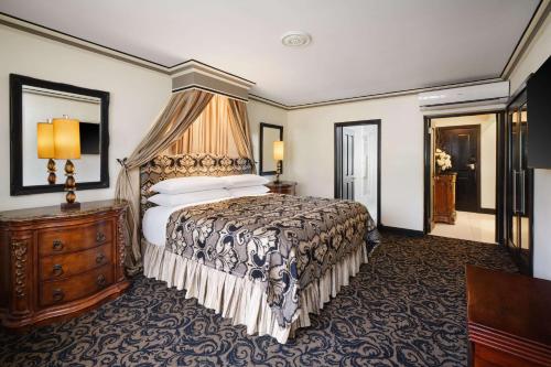 a hotel room with a large bed and a dresser at Terra Nova, BW Premier Collection in Kingston