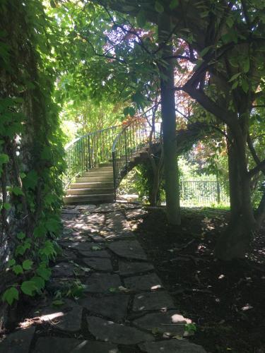 a walkway through a garden with a fence at Botanic Garden Lake Como in Blevio