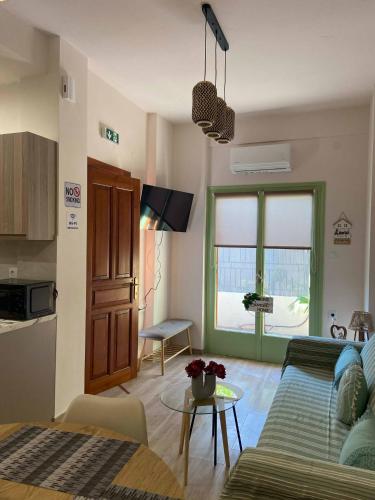 a living room with a couch and a table at ZoYa ‘s Apartments in Agria