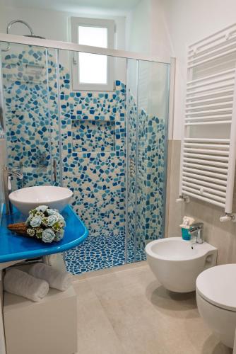 a bathroom with a shower and a toilet and a sink at Maison Margot in Forio d'Ischia