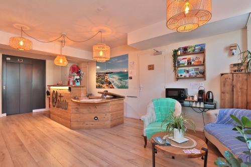 a living room with a couch and a table at Hôtel & Appart-hôtel Olatua in Bidart