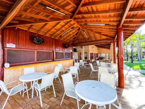 un grupo de mesas y sillas en un restaurante en Hotel Pousada Brilho do Sol, en Olímpia