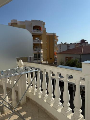 a white balcony railing with a bird sitting on it at Vironas Hotel in Himare