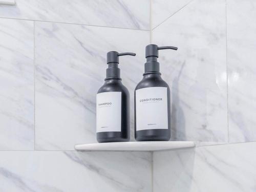two bottles on a shelf in a bathroom at 4BR 3BATH Harvard MIT Home in Cambridge