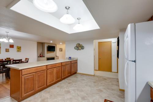 a large kitchen with a large counter and a refrigerator at Fairbanks Alaskan Abode about 1 Mile to Pioneer Park! in Fairbanks