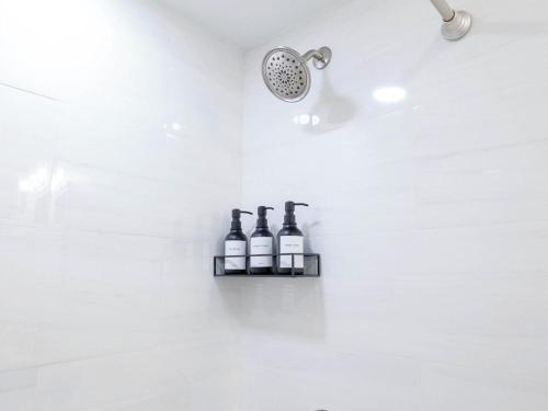 a bathroom with three bottles of wine on a shelf at 4BR 3BATH Harvard MIT Home in Cambridge