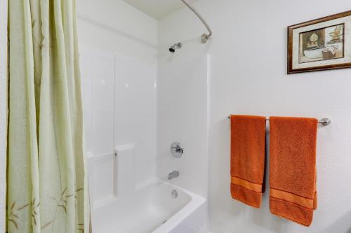 a bathroom with orange towels hanging on the wall at Fairbanks Alaskan Abode about 1 Mile to Pioneer Park! in Fairbanks
