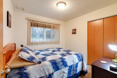 a bedroom with a bed and a dresser and a window at Fairbanks Alaskan Abode about 1 Mile to Pioneer Park! in Fairbanks
