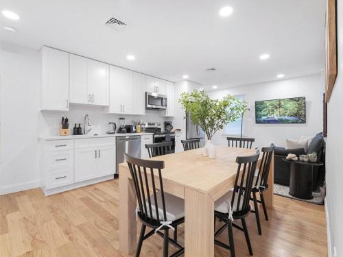 a kitchen and dining room with a wooden table and chairs at 4BR 3BATH Harvard MIT Home in Cambridge