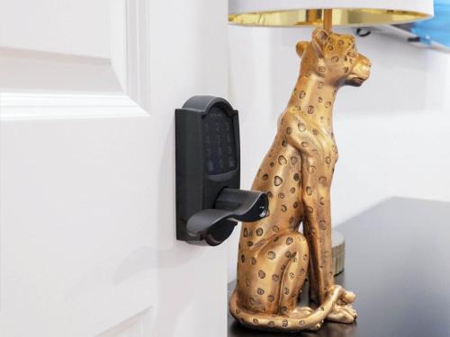 a statue of a dog holding a phone on a wall at 4BR 3BATH Harvard MIT Home in Cambridge
