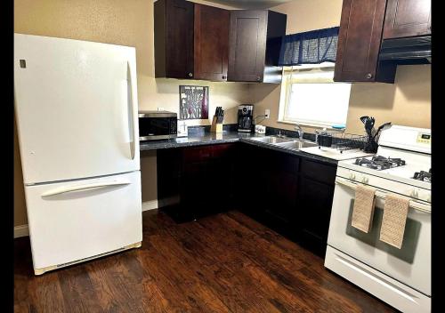 a kitchen with a white refrigerator and a stove at Miami Court Single Cottage #1 in Lakeland