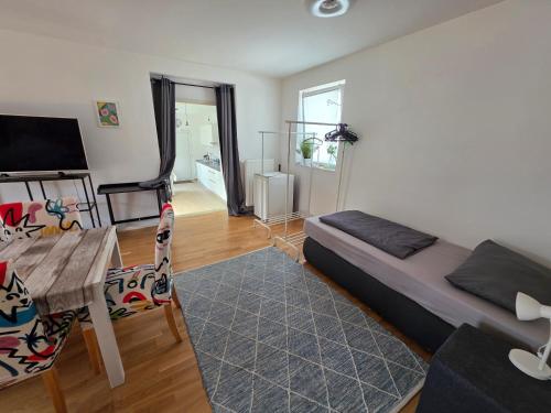 a bedroom with a bed and a table and a desk at Monteurwohnungen Maintal Frankfurt Hanau Bad Vilbel in Maintal