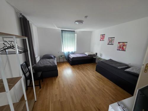 a living room with two beds and a staircase at Monteurwohnungen Maintal Frankfurt Hanau Bad Vilbel in Maintal