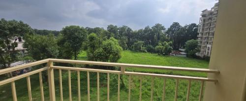 a balcony with a view of a field and trees at Hotel Curl in Jāmb