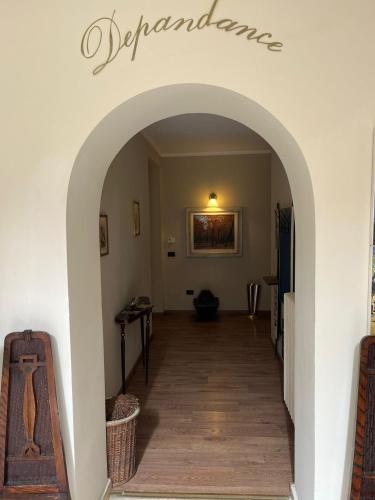 a hallway with an archway in a house at Hotel Villa dei Pini in San Terenziano