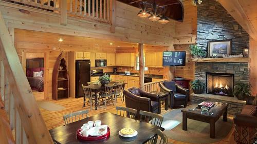 a living room and kitchen with a fireplace in a cabin at Bluegreen Vacations Blue Ridge Village, an Ascend Collection Resort in Banner Elk