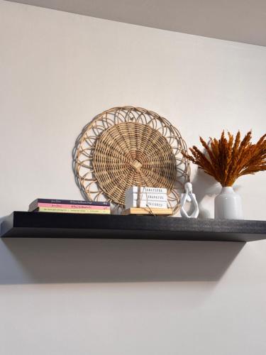 a shelf with a fan and books on a wall at Condo in Lapu-Lapu City in Suba