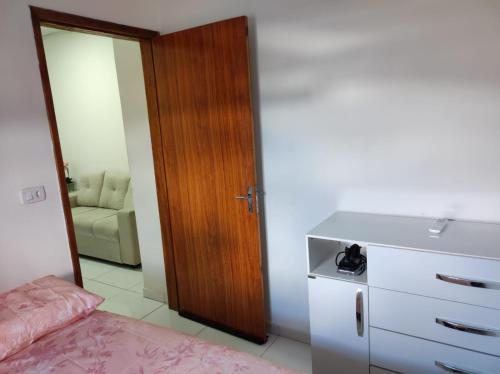 a kitchen with a dresser and a refrigerator at Apartamento tipo kitnet mobiliado in União dos Palmares