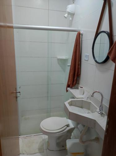 a bathroom with a toilet and a sink and a mirror at Apartamento tipo kitnet mobiliado in União dos Palmares