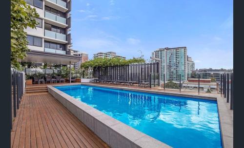 a large blue swimming pool on a building at 54Q Abnb-Style Apt Discover Riverside Bliss with Pool and Free Parking near Portside in Brisbane