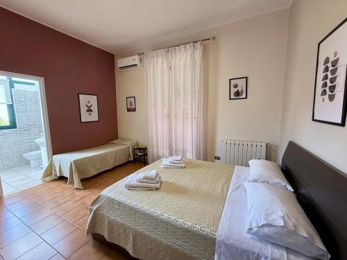 a bedroom with two beds and a bathroom at Etna Volcano Relais- Indipendent Villa in Mascalucia
