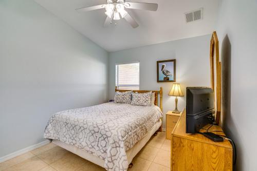 a bedroom with a bed and a flat screen tv at 4 Mi to Beaches Fort Myers Escape with Patio in Fort Myers