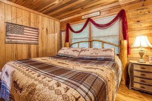 a bedroom with a bed and an american flag at VIEW, Hottub, Pool table, Pet Friendly! in Sevierville