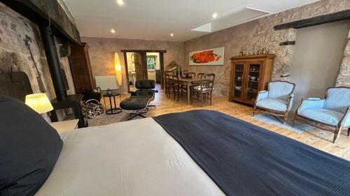 a bedroom with a large bed and a dining room at ZONE BLEUE in Hyds