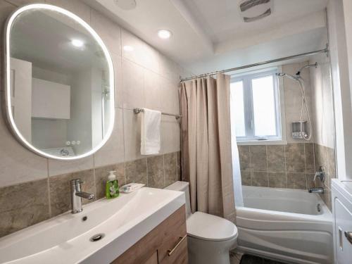 a bathroom with a sink and a toilet and a mirror at 3BR 6Beds 5min Walk Metro Free Parking Place Bell in Laval