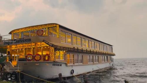 a boat sitting in the water with its lights on at Green tourism Alleppey in Alleppey