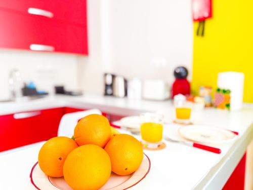 a pile of oranges on a plate on a kitchen counter at Little Palmar with Free Parking & Pool & Padel in Palm-Mar