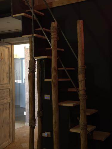 a wooden spiral staircase in a room at The Bridge Suites in Gravina in Puglia