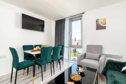 a living room with a table and chairs and a couch at 2 Bedroom 2 Bathroom Apartment with 5 Beds and Gated Parking near Sheffield United Stadium in Sheffield