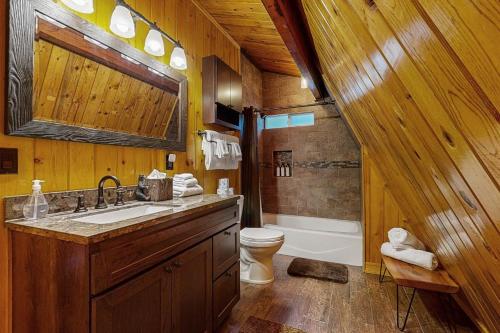 a wooden bathroom with a sink and a toilet at Primrose Cabin #709 in Big Bear Lake