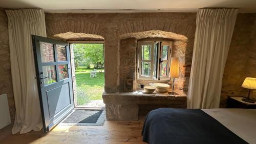 a bedroom with a bed and an open door at ZONE BLEUE in Hyds