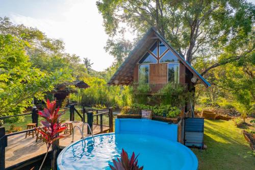 a small house with a pool in the yard at Wisdom Bungalow- Habarana in Moragaswewa