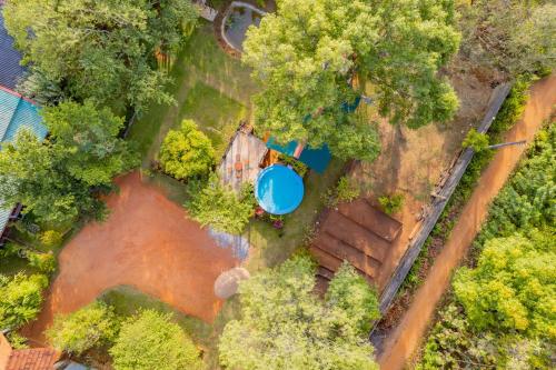 an overhead view of a farm with a blue pond at Wisdom Bungalow- Habarana in Moragaswewa
