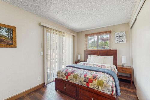 ein Schlafzimmer mit einem Bett und einem Fenster in der Unterkunft Meadow-Front Metcalf Bay Gem #542 in Big Bear Lake