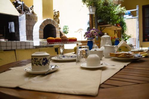 a table with cups and plates of food on it at Pimpioxelli in Quartucciu