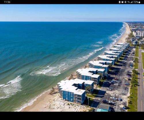 an aerial view of a beach with buildings and the ocean at Steps To The Ocean! 285 in North Topsail Beach