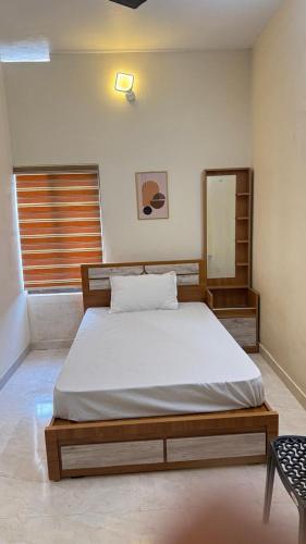 a bedroom with a bed and a mirror in it at HG Tower 2 in Kunnamangalam