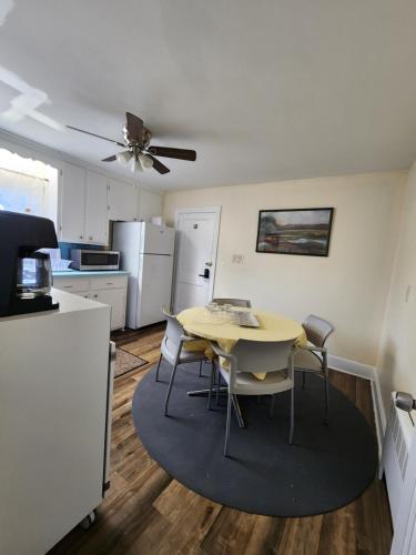 a kitchen with a table and chairs in a room at Planet smart in Boston