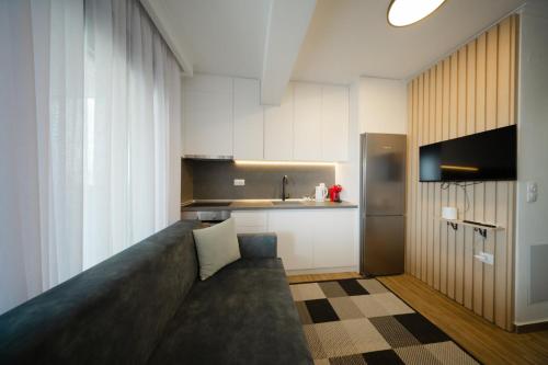 a living room with a couch and a kitchen at Tower Luxury Flats in Alexandroupoli