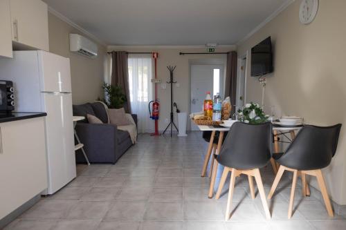 a kitchen and a living room with a table and chairs at Azorean Stays T1-Relaxing 1-Bedroom Retreat Near São Miguel Highlights in Lomba da Cruz
