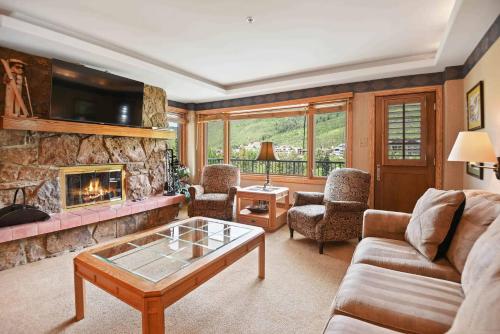 a living room with a couch and a fireplace at Lodge Tower 594 One Bedroom Residence in Vail