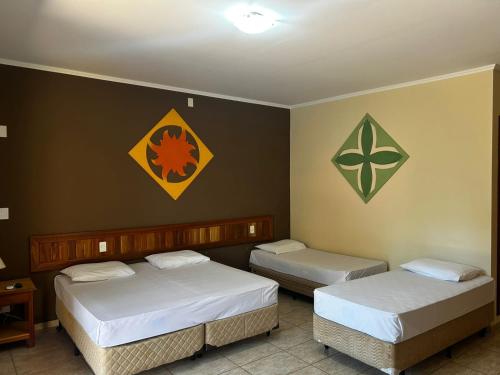 Cama o camas de una habitación en Hotel Pousada Brilho do Sol