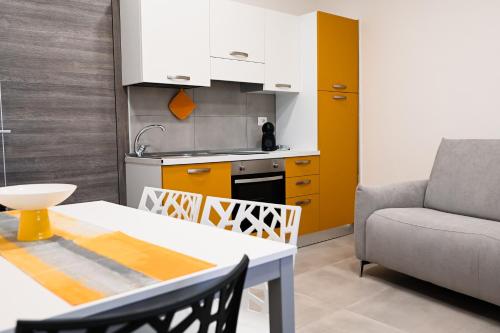 a kitchen and dining room with a table and a couch at Dimora Domitia - Apartments in Mondragone