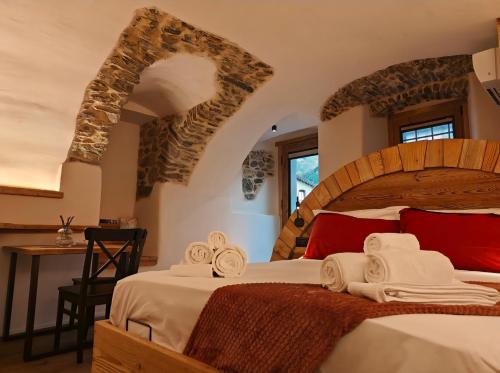 a bedroom with a large bed with towels on it at Le Grenier d'Antan - Relax Suite in Aosta