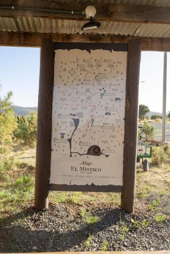 a sign in a field with writing on it at Ashley's Treehouse At El Mistico Ranch in Nogal