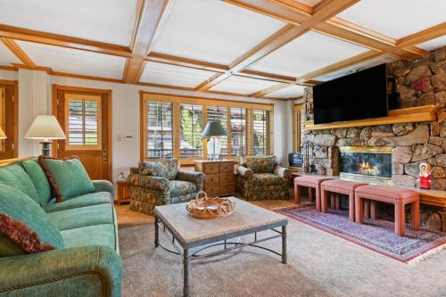 a living room with a couch and a fireplace at Lodge Tower 599 One Bedroom Residence in Vail